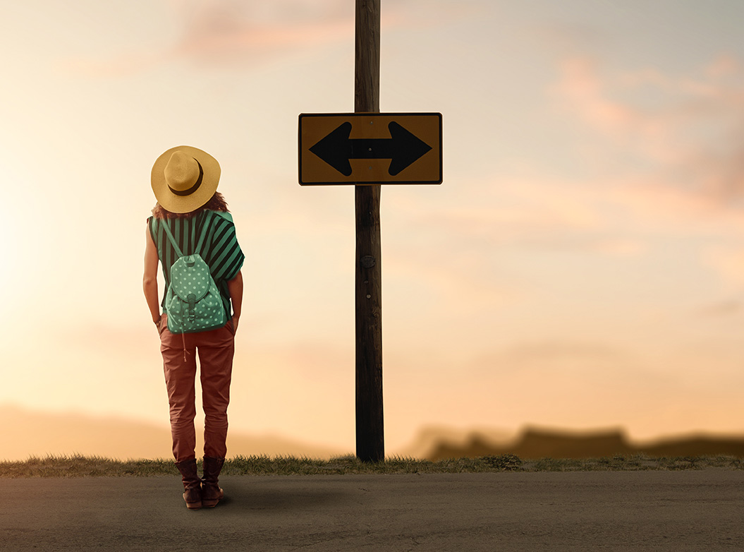 Woman at a crossroads contemplating how to make a change